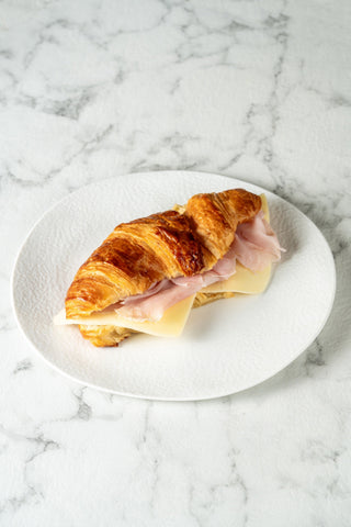 Warm croissant with ham and cheese