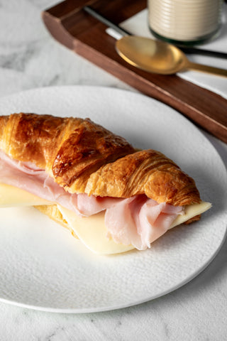 Warm croissant with ham and cheese