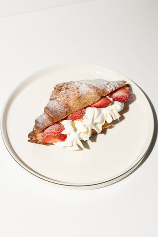 Croissant with whipped cream and strawberries