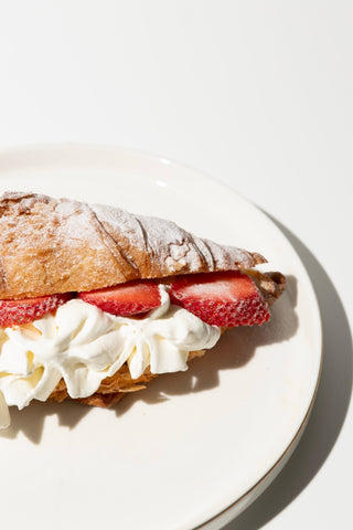 Croissant with whipped cream and strawberries